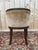 A louis xvi style office chair in a dark walnut-stained carved wood, with tapered and fluted legs topped with carved...