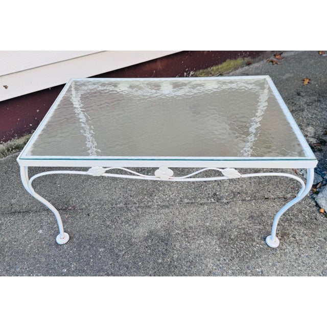 Vintage 1960s White Wrought Iron Glass Top Coffee Table Bring timeless garden-inspired elegance to your space with this...