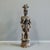 Hand carved from a single piece of wood, this vintage Nigerian figure of a mother with child on her back, rests on a small...
