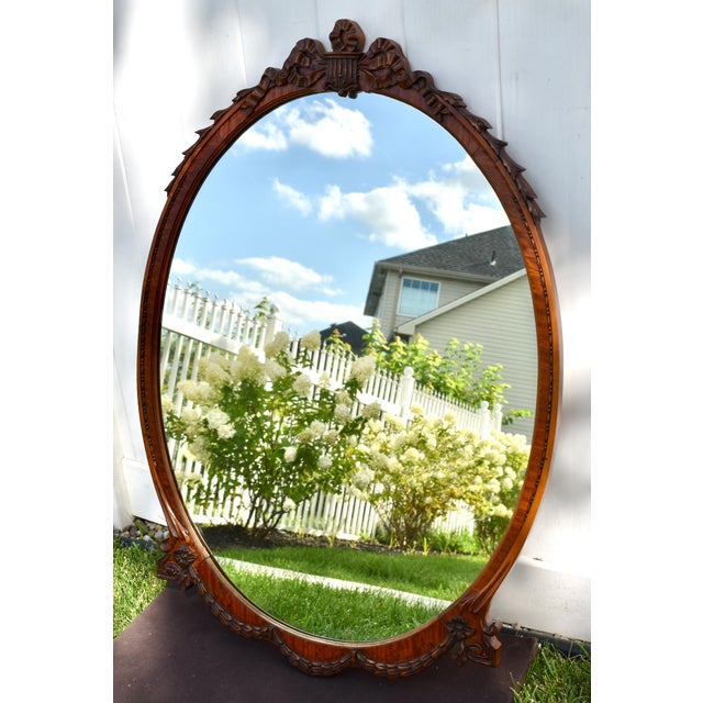 Vintage (1940's) Wall Mirror has a French Style. The Wood is Satinwood. Carved Wood Frame. Oval Shape with Basket Crest....