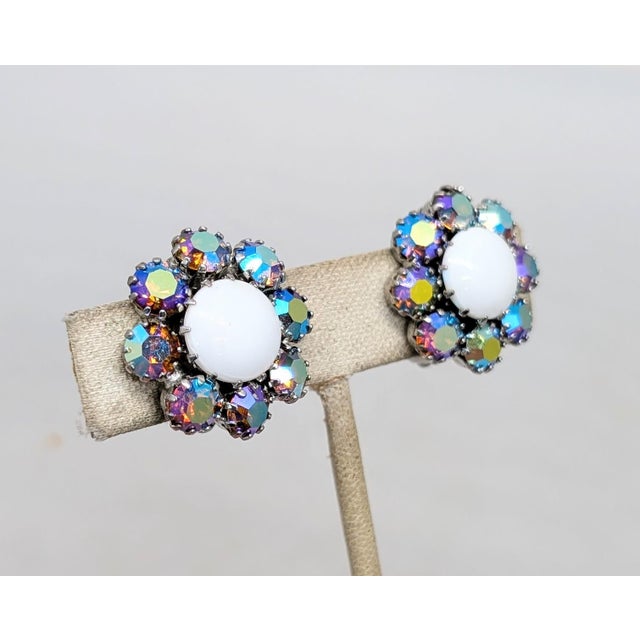 Late 1950s or 1960s rhodium plated prong set white cabochon rhinestone center with round aurora borealis surround clip...