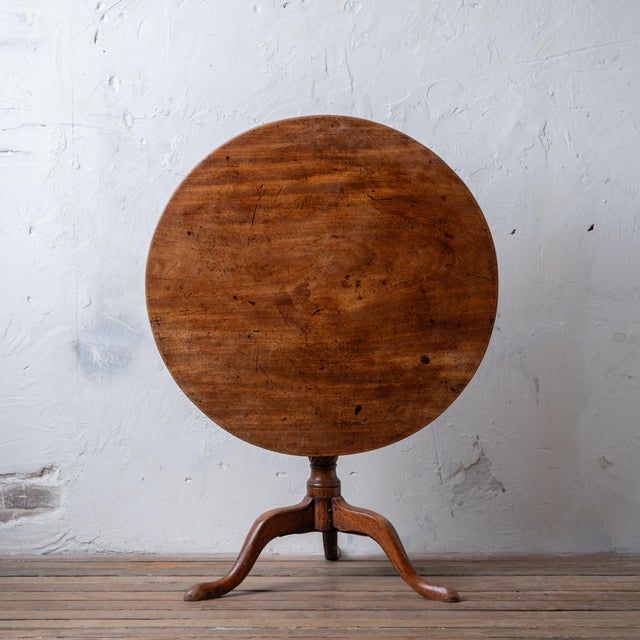 A George III mahogany tilt-top table, 18th century. 32 inches wide by 32 ⅝ inches deep by 27 inches tall; 45 inches tall...