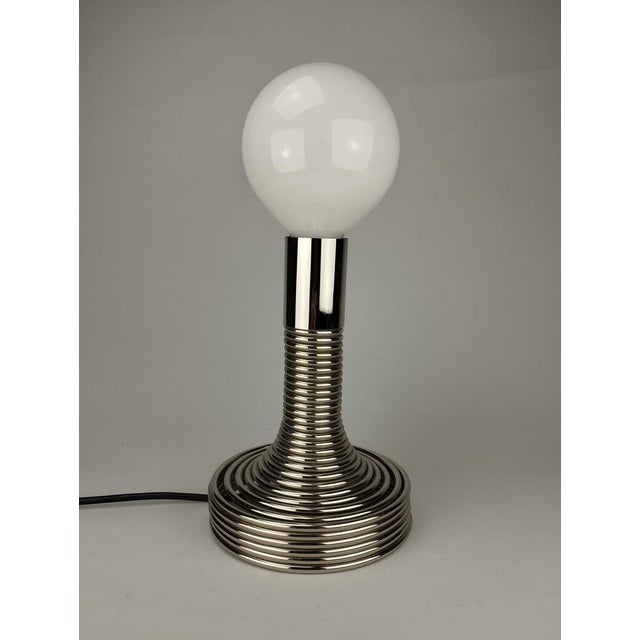 The iconic "Spirale" table lamp was designed by Angelo Mangiarotti for the Milanese manufacturer Candle. It consists of a...