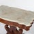 An antique American Empire Classical Greco center table offers beveled and shaped marble top over double scroll base...