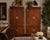 A handsome pair of Henredon Scene One campaign-style armoires crafted in beautifully figured walnut with distinctive solid...