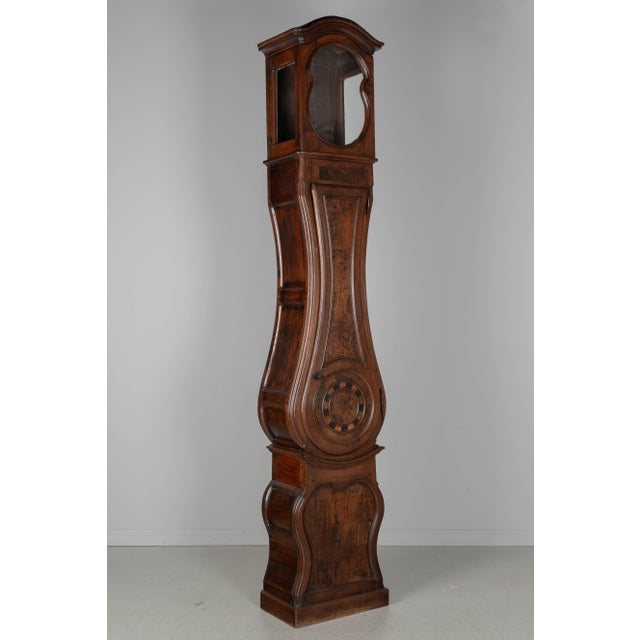 A 19th century French Horloge de Parquet, or tall case clock, from Burgundy. The case is made of solid walnut with burl of...