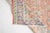 This is a vintage Turkish Oushak rug from the Mid 20th Century. The piece was hand-knotted.