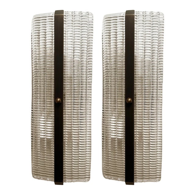 Set of two trasparent diamanted Murano glass wall sconces with Metal frame on view in Brunish- brunito . Murano glass with...