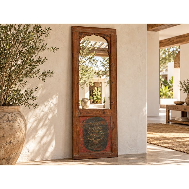 The cusped arch is what draws you in: a scalloped opening framed by carved spandrels in a weathered, honey-brown frame,...