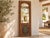 The cusped arch is what draws you in: a scalloped opening framed by carved spandrels in a weathered, honey-brown frame,...