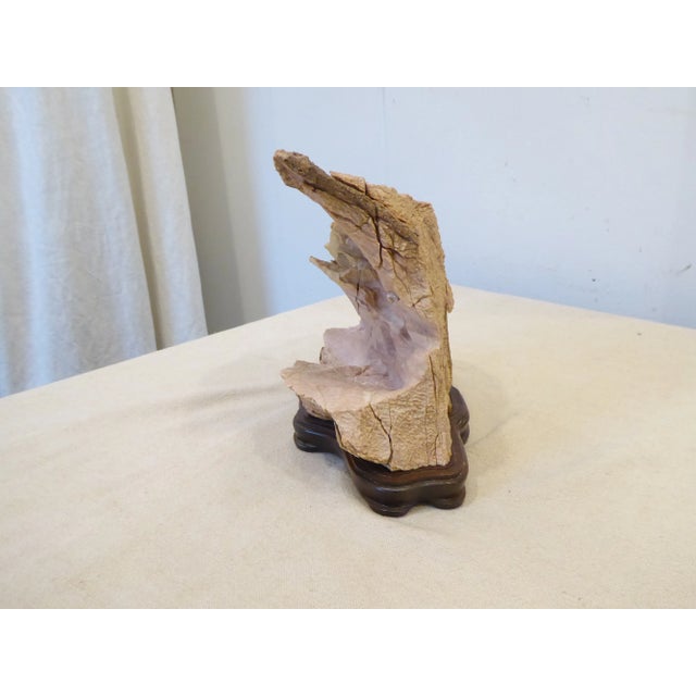 Marble scholar's rock on carved wooden stand.