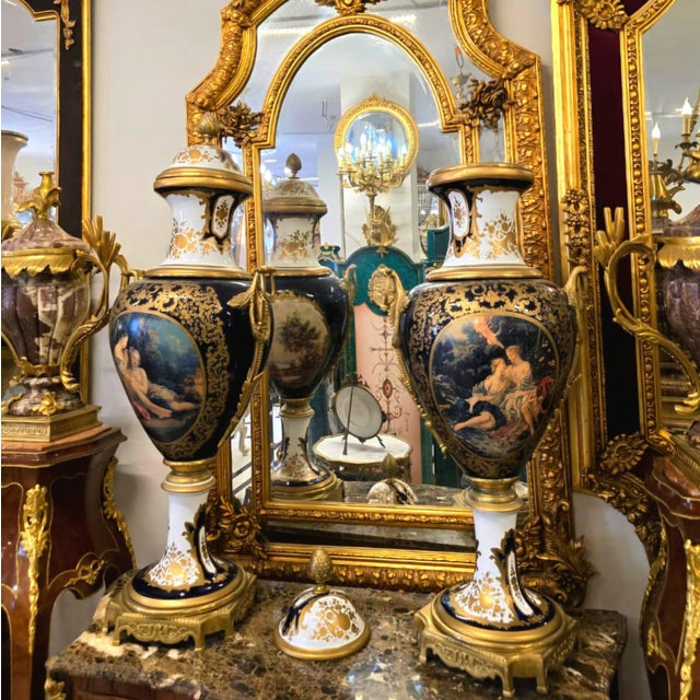 Elevate your décor with this exquisite hand-painted porcelain urn vase, featuring a romantic classical scene framed by...