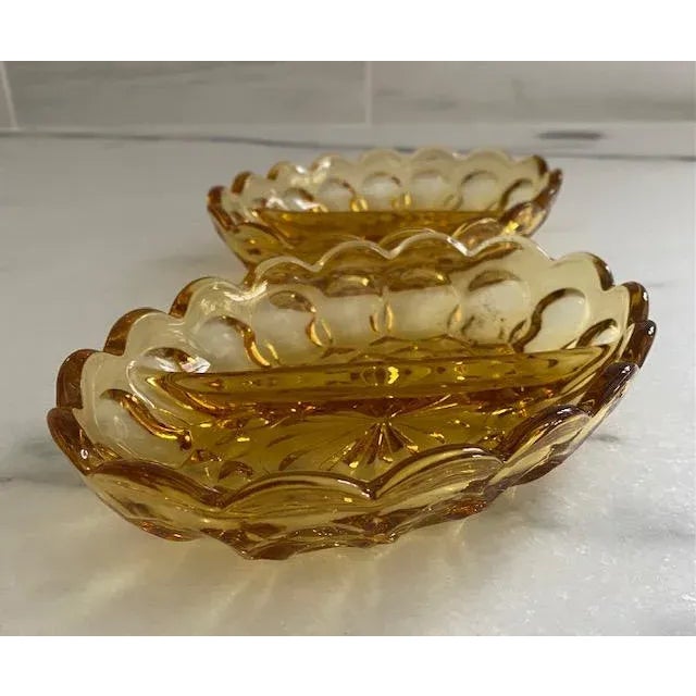 This pair of gorgeous vintage amber glass divided oval dishes was made by Anchor Hocking in the 1960s. A lovely gold hue,...