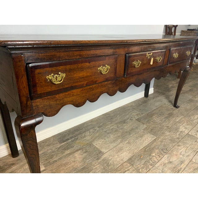 A very nice 18th Century Oak Dresser Base. Large scalloped apron and chamfered rear legs. Excellent color and patina to...