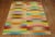A one of a kind one-off Turkish Kilim featuring a rainbow color palette.