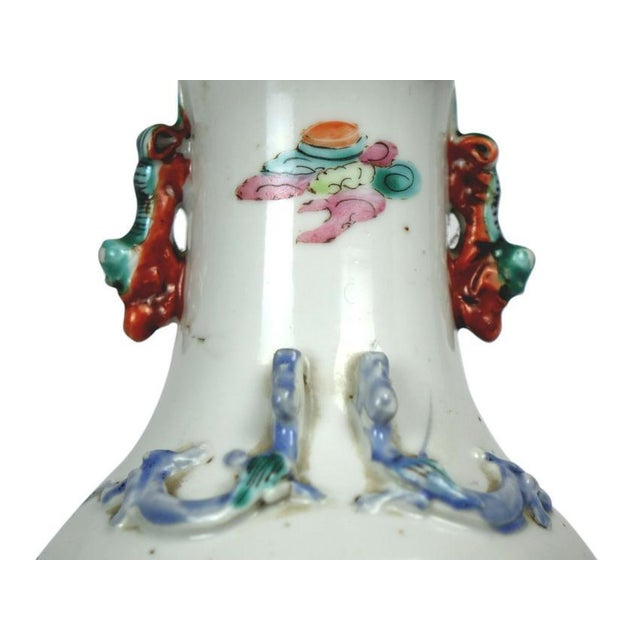 Elegant Antique Chinese Porcelain Vase featuring intricate floral designs and delicate depictions of people in traditional...