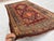 This antique hand-knotted Shirvan Akstafa rug features stacked serrated star medallions in burgundy and brown, set against...