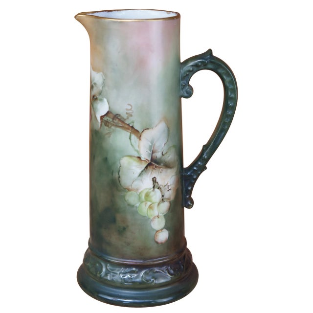 This antique tankard was made around the turn of the century in France. Features beautiful hand painted grapes over a...