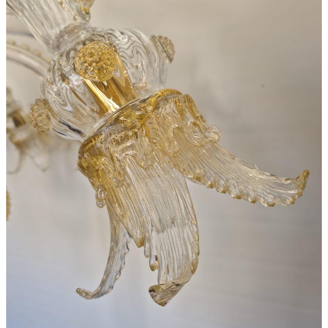 Venetian Classical Transparent and gold Murano glass chandelier with flowers and leaves. Traditional piece of Italian art...