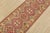 A tribal Caucasian Kazak runner hand-knotted with fine wool on a cotton foundation. This rug features a row of geometric...