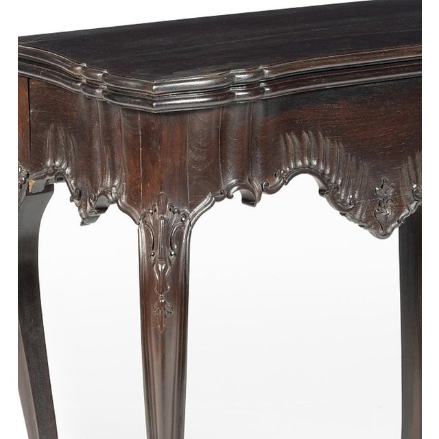 Portuguese style tea table in Noble Wood, King Jose style; carved Noble Wood; decorated with vegetal motifs. Rests on four...