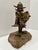 Brutalist metal sculpture depicting a whimsical Viking warrior with horned helmet, dimensional beard, layered armor, round...