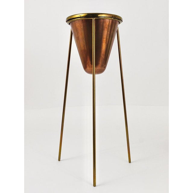 A rare modernist vintage floor standing ashtray from the 1950s, designed and executed by Carl Auböck, Vienna. The bowl of...