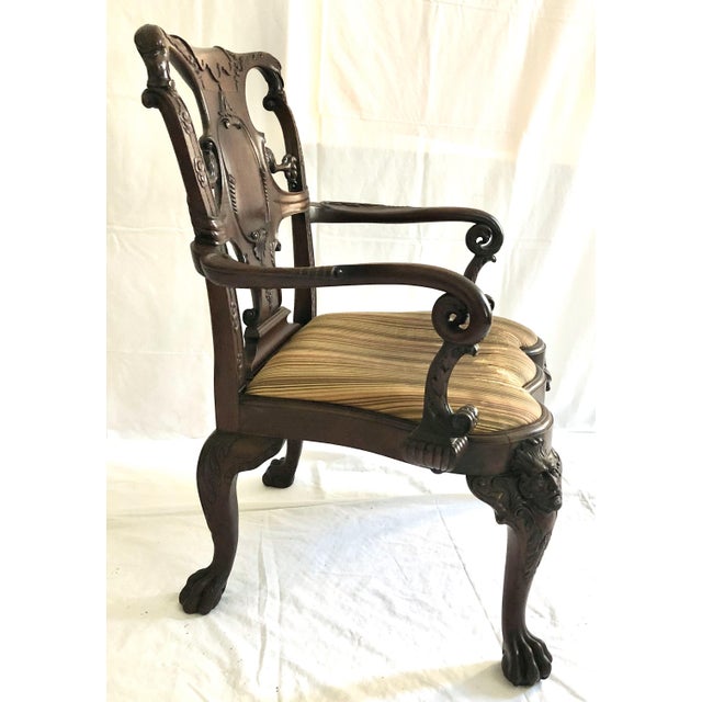 A Early 20th c. Exuberantly Carved Chippendale Mahogany Arm Chair by Schmieg & Kotzian, with a Slip Seat. 32"x 30"x...