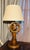 A wonderfully character-rich nautical table lamp crafted in warm-toned wood with an integrated ship’s wheel functioning as...