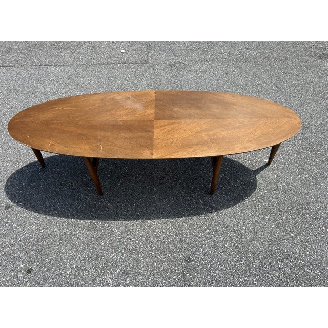 This elegant surfboard-style coffee table was meticulously crafted from walnut, it features a distinctive base with...
