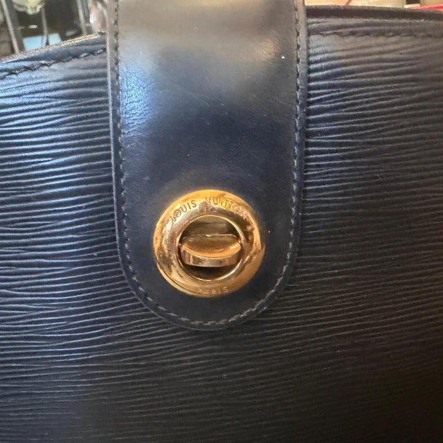 An iconic 1995 Louis Vuitton Cluny shoulder bag, expertly crafted in France from signature Noir (black) Epi textured...