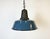 Industrial blue enamel pendant light made in Poland during the 1960s. White enamel inside the shade. Cast iron top. The...