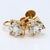 Here is a pair of 14k yellow and white gold stud earrings. Each earring features a round white diamond at the center,...