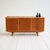 Teak sideboard with light wood details, pull-out top, hinged doors, and drawers. Scandinavian production, 1960s....