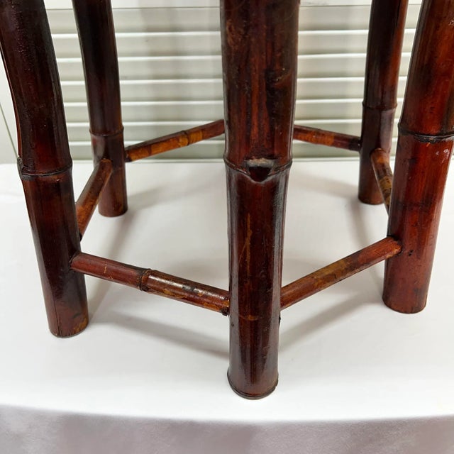 Hexagon burnt bamboo drink table with woven rattan covering the top and edge. Stretchers between each leg top and bottom...