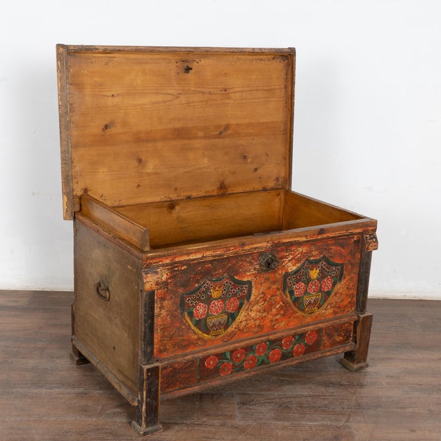 The colorful paint is all original on this beautiful flat top trunk. Flowers were a traditional embellishment as seen on...