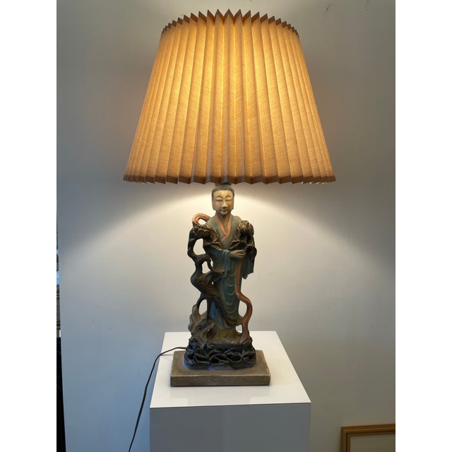 Vintage 1940s Chinoiserie figural table lamp depicting a serene robed female figure in the style of Guanyin, accompanied...