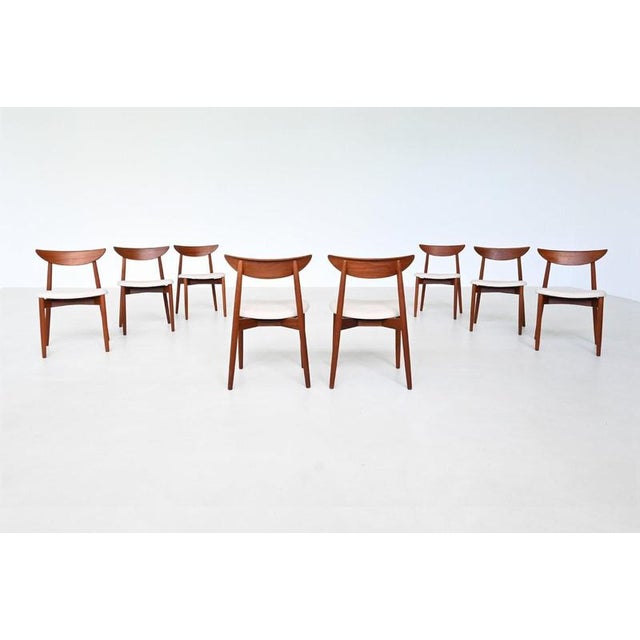Elegant set of eight dining chairs designed by Harry Østergaard for Randers Møbelfabrik, Denmark, 1960. These sculptural...