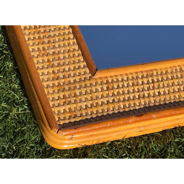 A magnificent pair of vintage mirrors crafted from natural bamboo and woven rattan, authentic examples of European design...