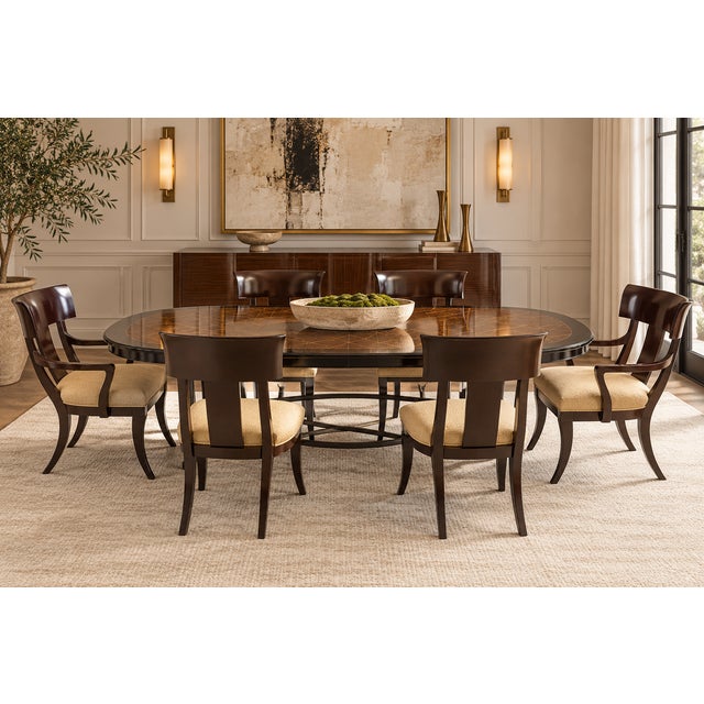 A striking set of six Henredon neoclassical dining chairs featuring a dramatic interpretation of the ancient Greek Klismos...