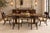 A striking set of six Henredon neoclassical dining chairs featuring a dramatic interpretation of the ancient Greek Klismos...