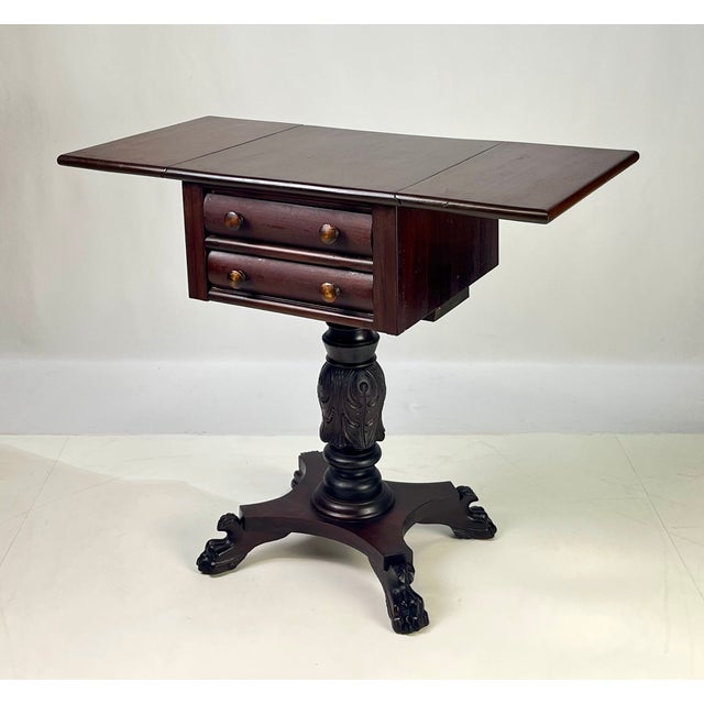 A great example of American Empire design, this 19th-century mahogany drop-leaf work table features a beautifully grained...