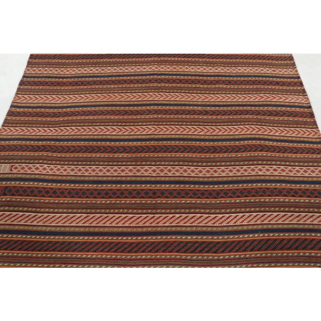 Made with handwoven wool circa 1950-1960, this 6x7 vintage Kilim is a particularly bright and sought-after work of an...