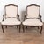Late 19th-century pair of Swedish walnut armchairs featuring carved detailing along the backs, arms, and skirts. The...