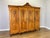 An elegant Vintage French Louis wardrobe crafted in Oak, featuring an impressive four-door design with richly carved...