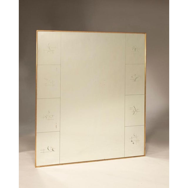 Art Deco-style mirror, original from the period, with a brass frame and decorative designs on the side panels. The...