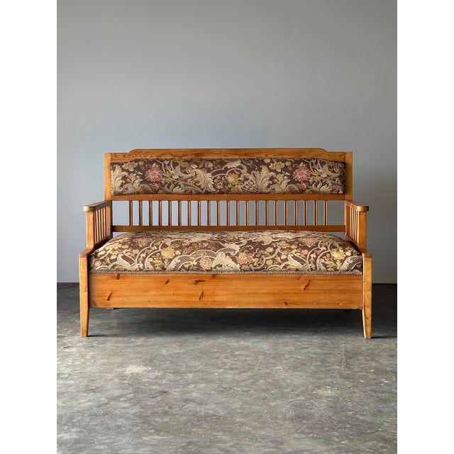 A wonderful antique Central European pine bench featuring slender spindle detailing and an ingenious multifunctional...