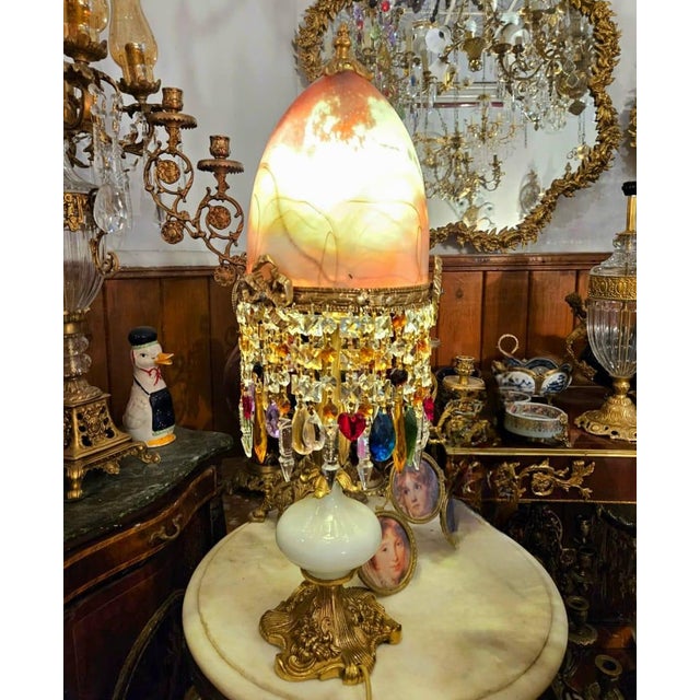 A breathtaking vintage table lamp featuring a luminous art glass shade in warm amber, cream, and honey tones, beautifully...