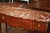 Elegant in both proportion and detail, this antique Louis XVI console combines refined marquetry, finely cast gilt-bronze...