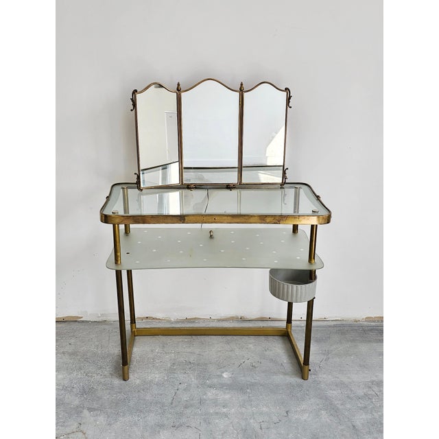 In this listing you will find an extremely elegant Mid Century Modern Vanity Table with a Triptych Mirror done in bronze...